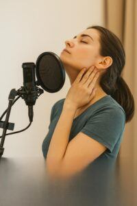 “Voice actor doing neck and jaw stretches before recording”