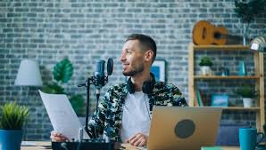 Voice actor recording at home with animated characters on screen.